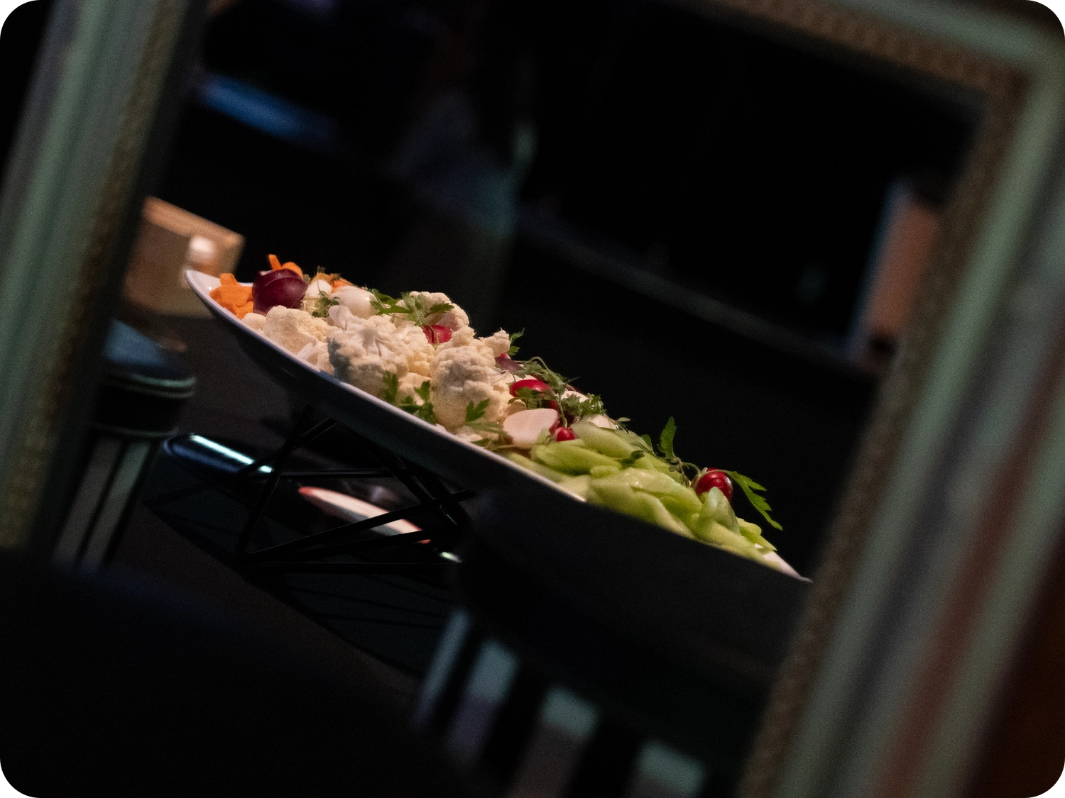 Plate of assorted raw vegetables on a table.